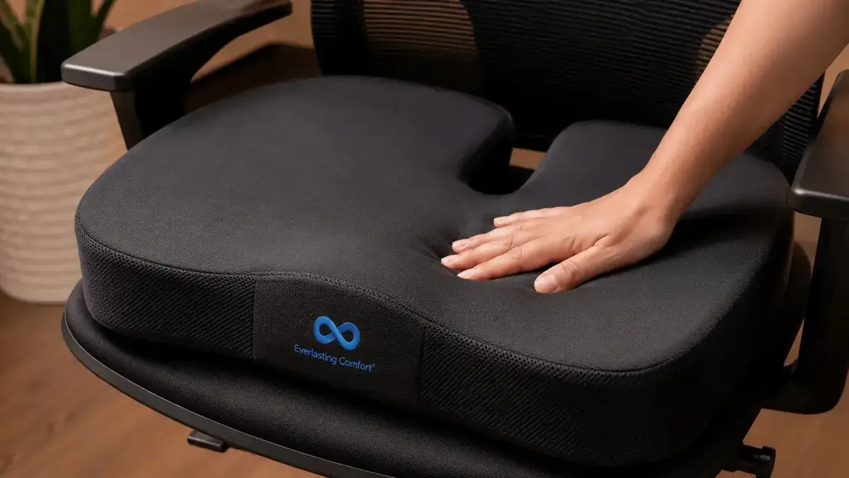 Close-up of a person adjusting their office chair seat-height lever with their hand, feet visible on the floor